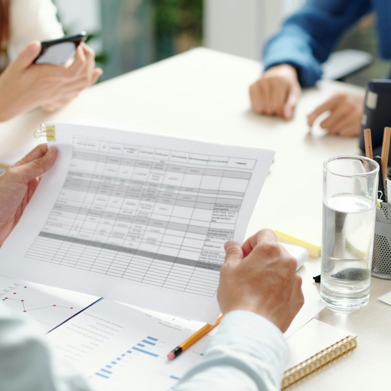 Team leader checking document with table